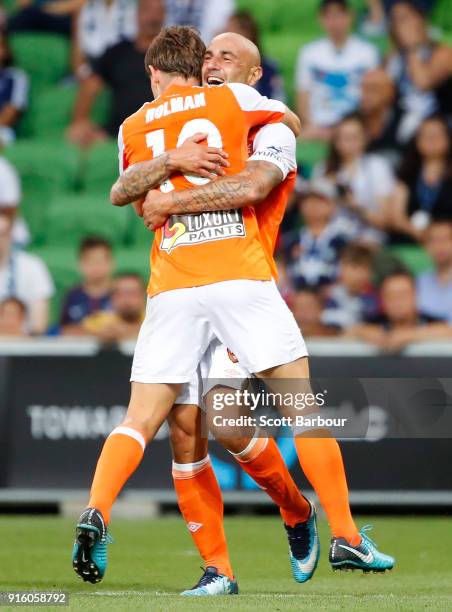 Brett Holman of the Roar is congratulated by Massimo Maccarone after scoring the Roars second goal during the round 20 A-League match between the...