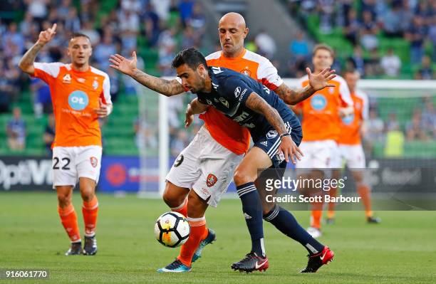 Massimo Maccarone of the Roar and Rhys Williams of the Victory compete for the ball during the round 20 A-League match between the Melbourne Victory...