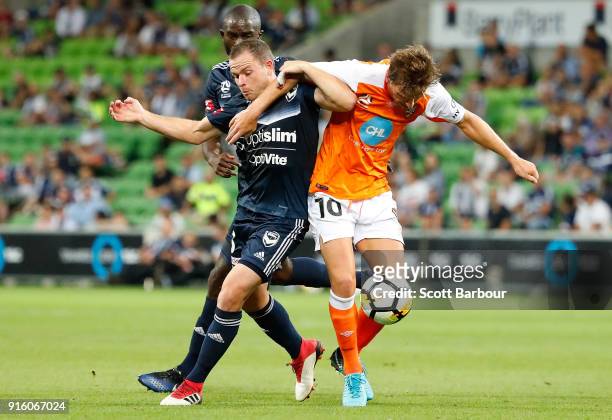 Brett Holman of the Roar and Leigh Broxham of the Victory compete for the ball during the round 20 A-League match between the Melbourne Victory and...