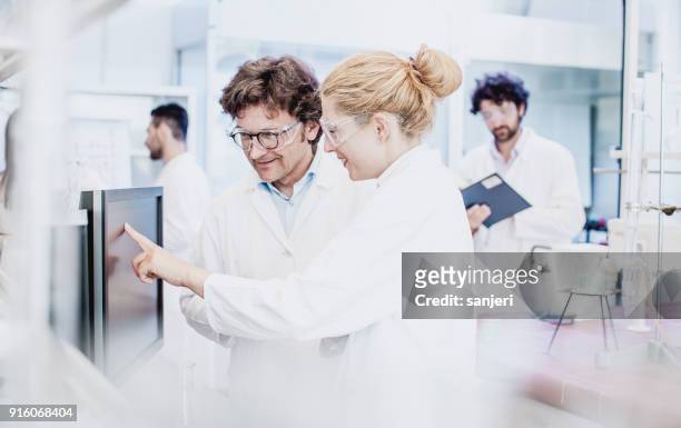 scientist working in the laboratory, using computer - computer scientist stock pictures, royalty-free photos & images