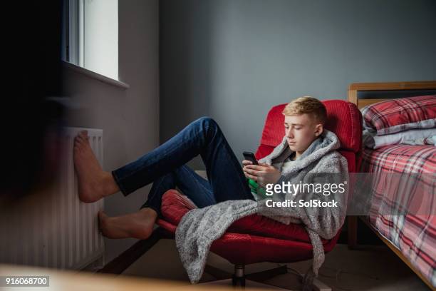 tiener jongen ontspannen in zijn slaapkamer - woonruimte stockfoto's en -beelden