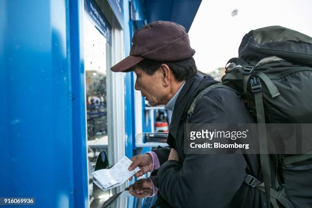 An attendee waits at the box office ahead of the opening ceremony for the 2018 PyeongChang Winter Olympic Games in the Hoenggye-ri village area of...