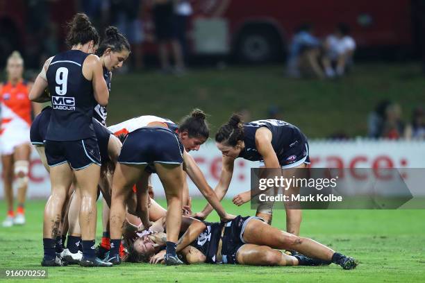 Blues players show concern for Katie Loynes of the Blues as she lies injured on the ground during the round 20 AFLW match between the Greater Western...