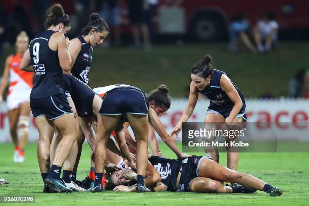Blues players show concern for Katie Loynes of the Blues as she lies injured on the ground during the round 20 AFLW match between the Greater Western...