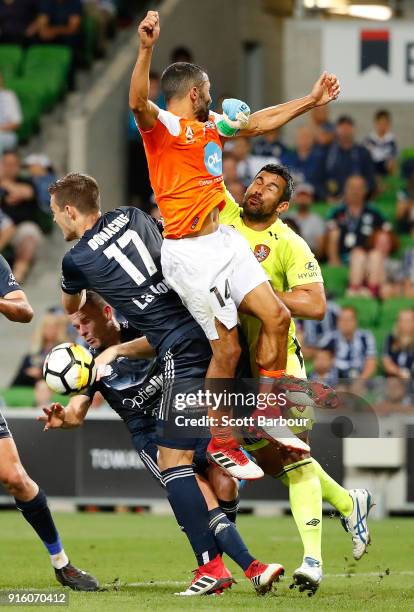 Goalkeeper Jamie Young and Fahid Ben Khalfallah of the Roar and Leigh Broxham and James Donachie of the Victory compete for the ball during the round...