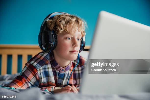 teenage boy using laptop - young teen stock pictures, royalty-free photos & images