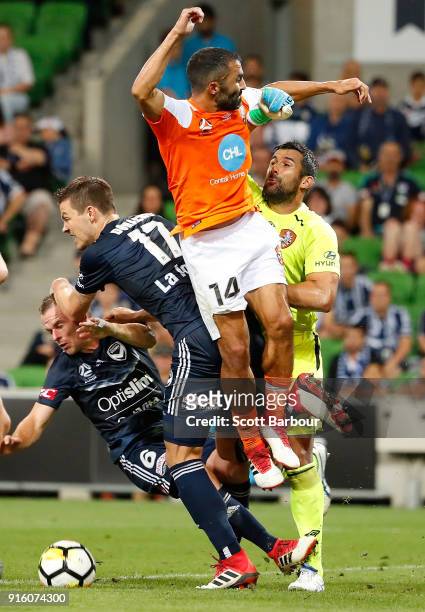 Goalkeeper Jamie Young and Fahid Ben Khalfallah of the Roar and Leigh Broxham and James Donachie of the Victory compete for the ball during the round...