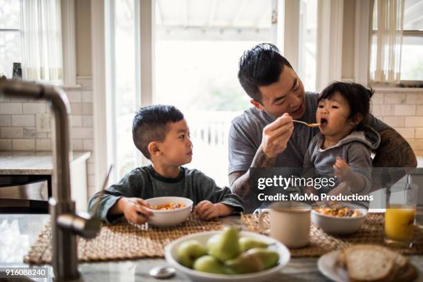 father and children having breakfast in kitchen - house husband stock pictures, royalty-free photos & images