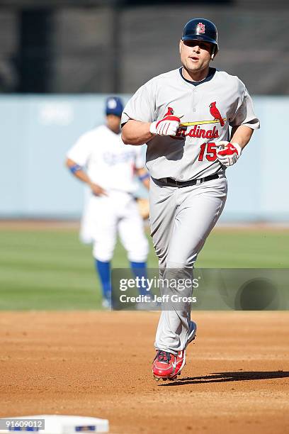 Matt Holliday of the St. Louis Cardinals rounds the bases after hitting a solo home run in the second inning against the Los Angeles Dodgers in Game...