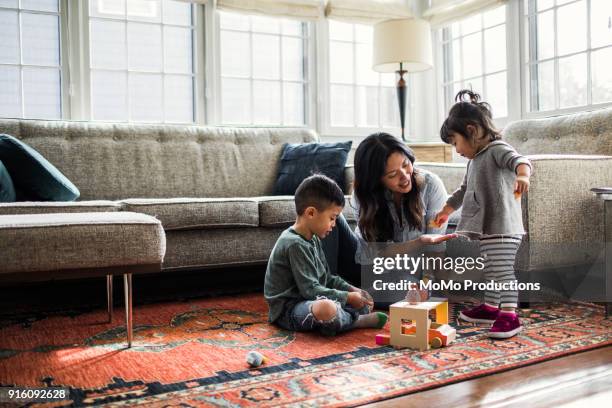 mother playing with kids at home - damaged carpet stock pictures, royalty-free photos & images