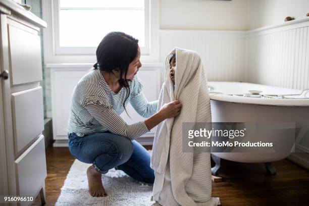 mother drying daughter off (2yrs) after bath - towel stock pictures, royalty-free photos & images