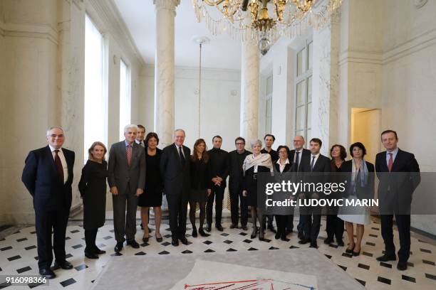 French president Emmanuel Macron poses for a family picture with french personnalities, Versailles resort president Catherine Pegard , former...