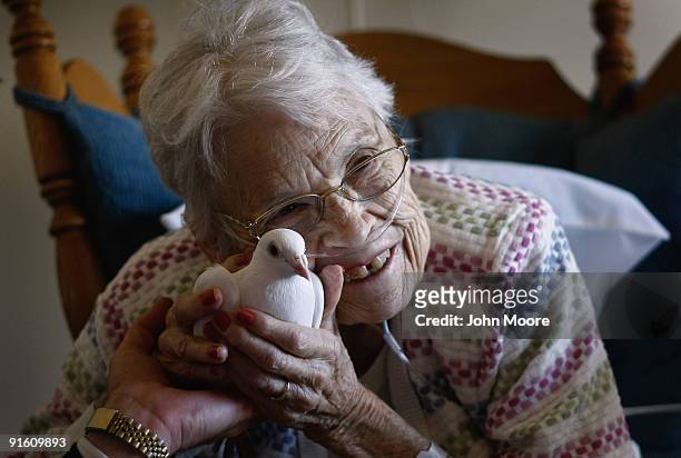 Terminally ill patient Evelyn Dafoe caresses a dove on October 7, 2009 at the Hospice of Saint John in Lakewood, Colorado. The dove visits are part...