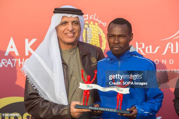 His Highness Sheikh Saud Bin Saqr Al Qasimi hands over the winner's trophy to Bedan Karoki from Kenya who won the Men's RAK Half Marathon in a time...