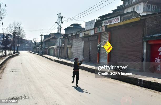 Boy flying a kite during curfew in Srinagar. Authorities imposed restrictions in some parts of Srinagar on Friday during a strike called by...