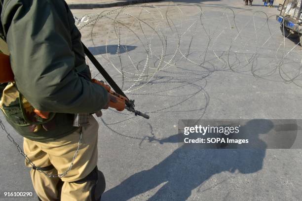 An Indian policeman stands guard during curfew in old city of Srinagar. Authorities imposed restrictions in some parts of Srinagar on Friday during a...