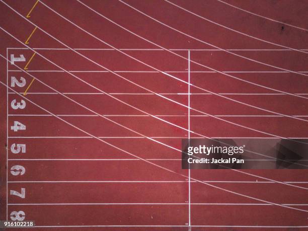 aerial view of an empty track and field stadium - leichtathletik stock-fotos und bilder