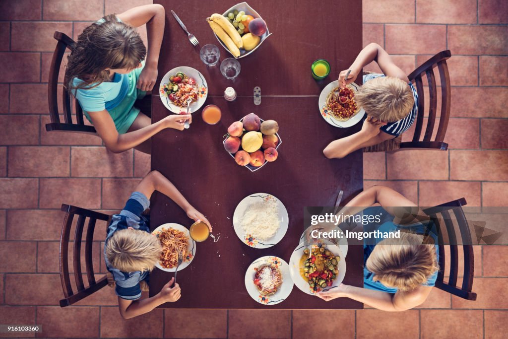 Family enjoying spaghetti lunch
