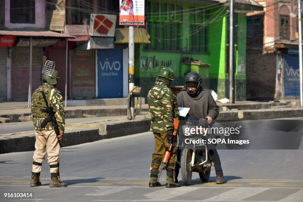 An Indian paramilitary trooper stops a motorcyclist during curfew in Srinagar. Authorities imposed restrictions in some parts of Srinagar on Friday...