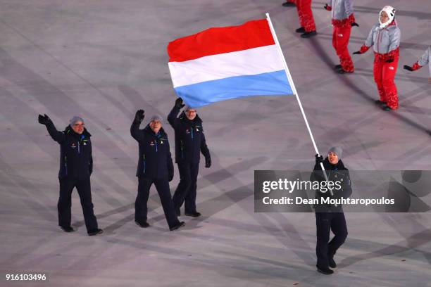 Flag bearer Mattheiu Osch of Luxembourg and teammates enter the stadium during the Opening Ceremony of the PyeongChang 2018 Winter Olympic Games at...