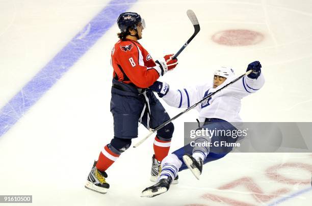 Alex Ovechkin of the Washington Capitals checks Jamal Mayers of the Toronto Maple Leafs at the Verizon Center on October 3, 2009 in Washington, DC.