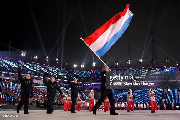 Flag bearer Mattheiu Osch of Luxembourg and teammates enter the stadium during the Opening Ceremony of the PyeongChang 2018 Winter Olympic Games at...