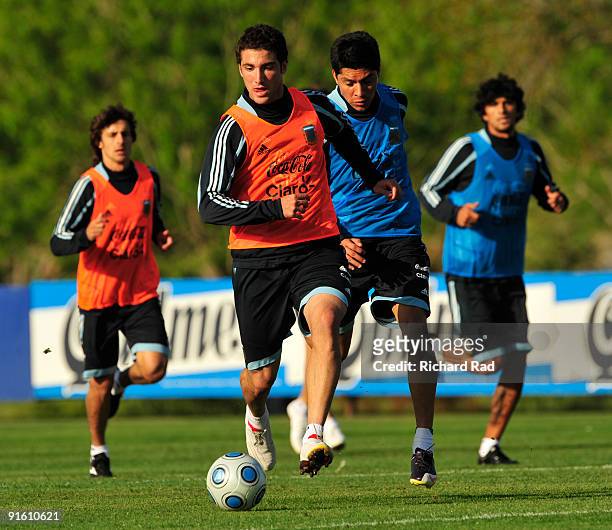 Argentina players Gonzalo Higuain vies for the ball with Nicolas Parejas during the Argentina training session at AFA building in Ezeiza on October...