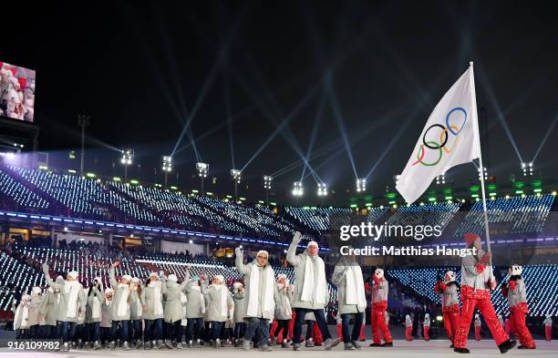 Flag bearer POCPG Volunteer of Olympic Athletes from Russia and teammates enter the stadium during the Opening Ceremony of the PyeongChang 2018...