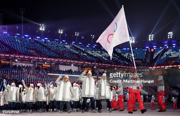 Flag bearer POCPG Volunteer of Olympic Athletes from Russia and teammates enter the stadium during the Opening Ceremony of the PyeongChang 2018...