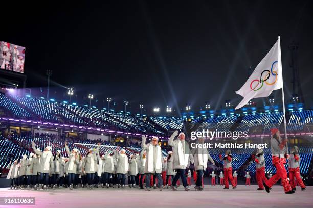 Flag bearer POCPG Volunteer of Olympic Athletes from Russia and teammates enter the stadium during the Opening Ceremony of the PyeongChang 2018...