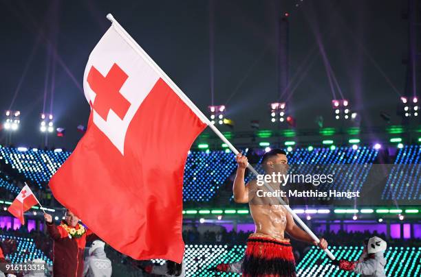 Flag bearer Pita Taufatofua of Tonga and teammates enter the stadium during the Opening Ceremony of the PyeongChang 2018 Winter Olympic Games at...