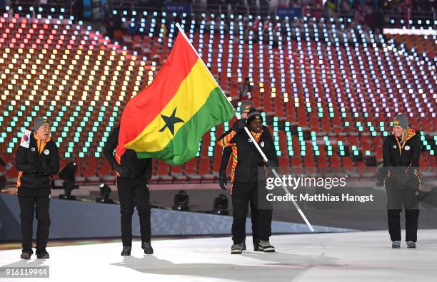 Flag bearer Akwasi Frimpong of Ghana and teammates enter the stadium during the Opening Ceremony of the PyeongChang 2018 Winter Olympic Games at...