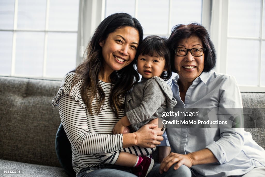 Grandmother, daughter and granddaughter on couch at home