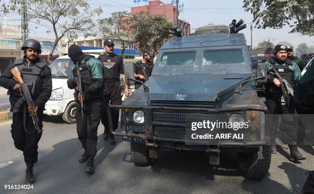 Pakistani policemen escort an armoured vehicle carrying the suspect accused of raping and murdering a young girl, outside an anti-terrorist court in...