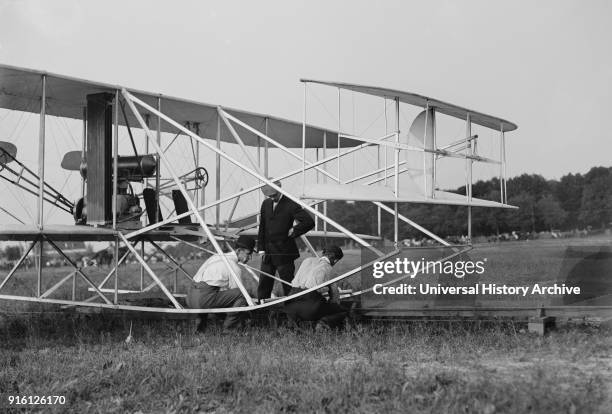 Wilbur and Orville Wright, Charlie Taylor Putting Airplane on Launching Rail, First Army Flights, Fort Myer, Virginia, USA, Harris & Ewing, July 1909.