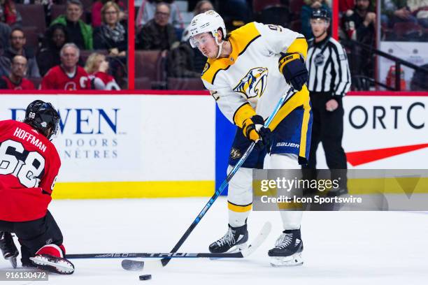 Nashville Predators Center Ryan Johansen passes the puck under the stick of Ottawa Senators Left Wing Mike Hoffman during overtime National Hockey...