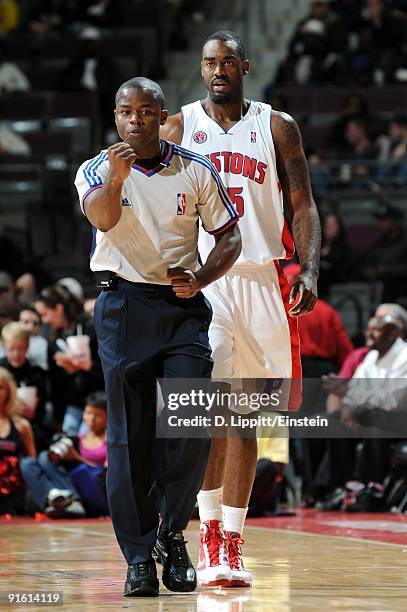 DaJuan Summers of the Detroit Pistons eyes referee Ken Washington as he makes a call during the preseason game against the Miami Heat at the Palace...