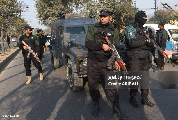 Pakistani policemen escort an armoured vehicle carrying the suspect accused of raping and murdering a young girl, outside an anti-terrorist court in...
