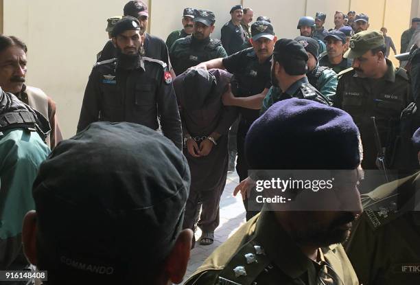 Pakistani policemen escort a suspect accused of raping and murdering a young girl, as they leave an anti-terrorist court after a hearing in Lahore on...