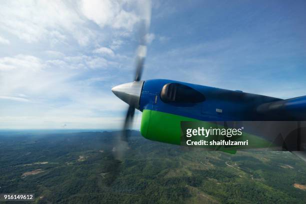 view of maswings twin otter aircraft in flight from miri to bario which take about 1 hour flight time. - propeller airplane bildbanksfoton och bilder