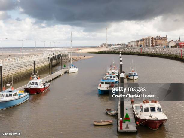boats moored on river clwyd at rhyl:the wales coast path between pensarn and chester - rhyl stock pictures, royalty-free photos & images
