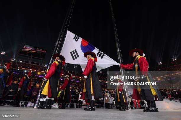 South Korean honour guards carry the national flag during the opening ceremony of the Pyeongchang 2018 Winter Olympic Games at the Pyeongchang...