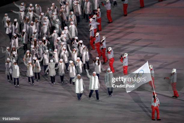 Flag bearer POCPG Volunteer of Olympic Athletes from Russia and teammatea arrive during the Opening Ceremony of the PyeongChang 2018 Winter Olympic...