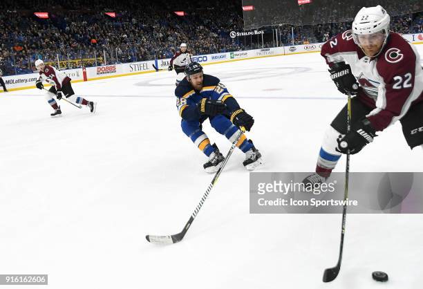 Colorado Avalanche center Colin Wilson goes after the puck on the boards with St. Louis Blues center Kyle Brodziak defending during a NHL game...