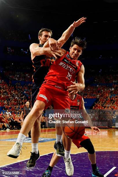 Mitch McCarron of the Taipans and Damian Martin of the Wildcats contest a rebound during the round 18 NBL match between the Perth Wildcats and the...