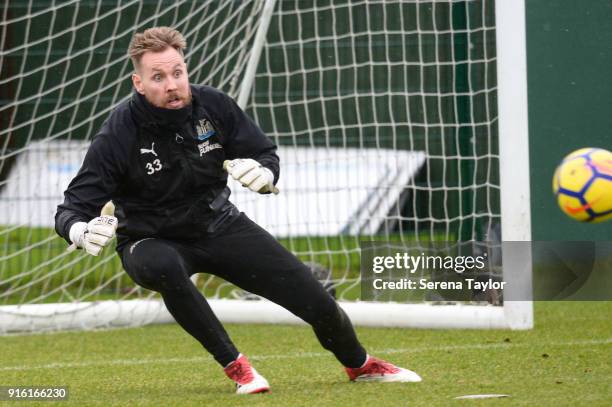 Goalkeeper Rob Elliot looks to make a diving save during the Newcastle United Training session at The Newcastle United Training Centre on February 9...