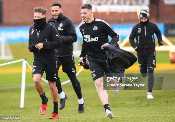 Ciaran Clark dashes to beat teammates seen L-R Dwight Gayle, Jamaal Lascelles and Ayoze Perez outside to start the Newcastle United Training session...