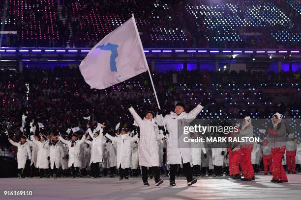 Unified Korea's flagbearers Hwang Chung Gum and Won Yun-jong lead the Unified Korea's delegation as they parade during the opening ceremony of the...