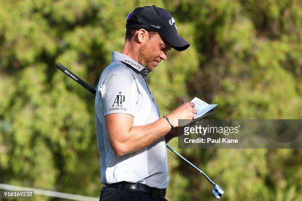 Danny Willett of England marks his score in his scorecard during day two of the World Super 6 at Lake Karrinyup Country Club on February 9, 2018 in...