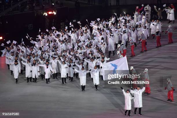 Unified Korea's flagbearers Hwang Chung Gum and Won Yun-jong lead the Unified Korea's delegation as they parade during the opening ceremony of the...